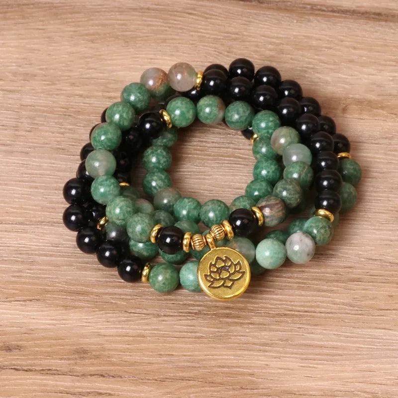 Green and black alloy beads on a stretch elastic bracelet band.
