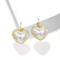 A pair of gold-coloured minimalist alloy ear clip earrings for women on a plain background.