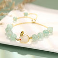 Rabbit charm bracelet with green aventurine and strawberry quartz stones on copper metal with gold accents