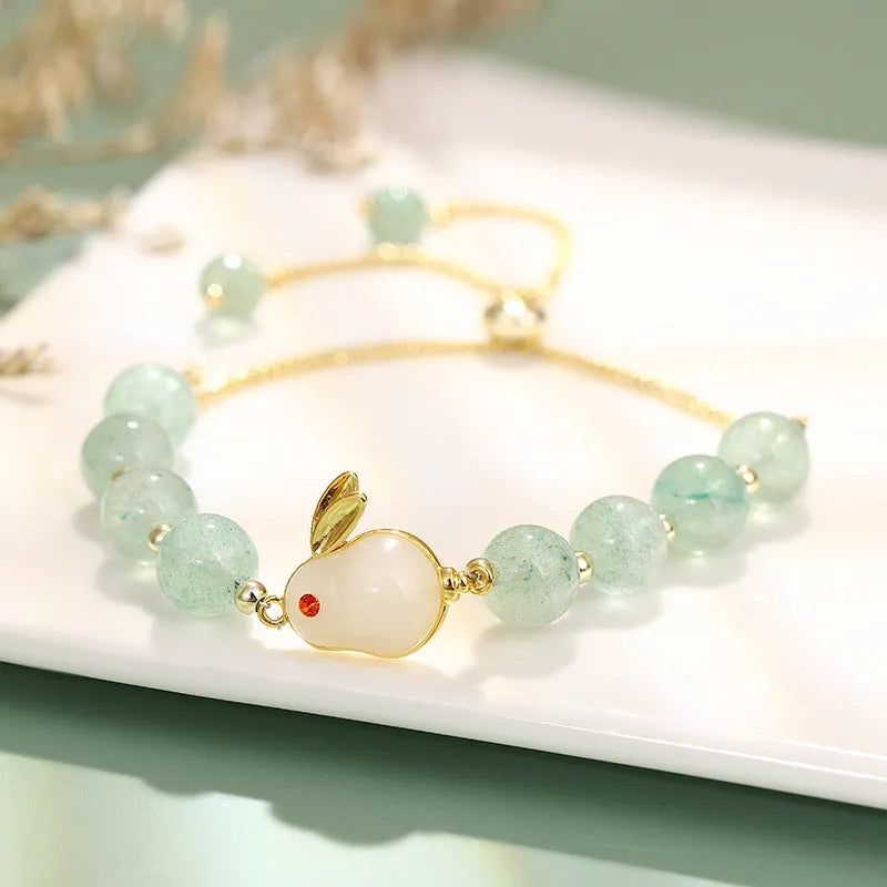 Rabbit charm bracelet with green aventurine and strawberry quartz stones on copper metal with gold accents