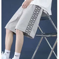 Men's loose-fit black track trousers with an elasticated waistband and baggy leg silhouette.