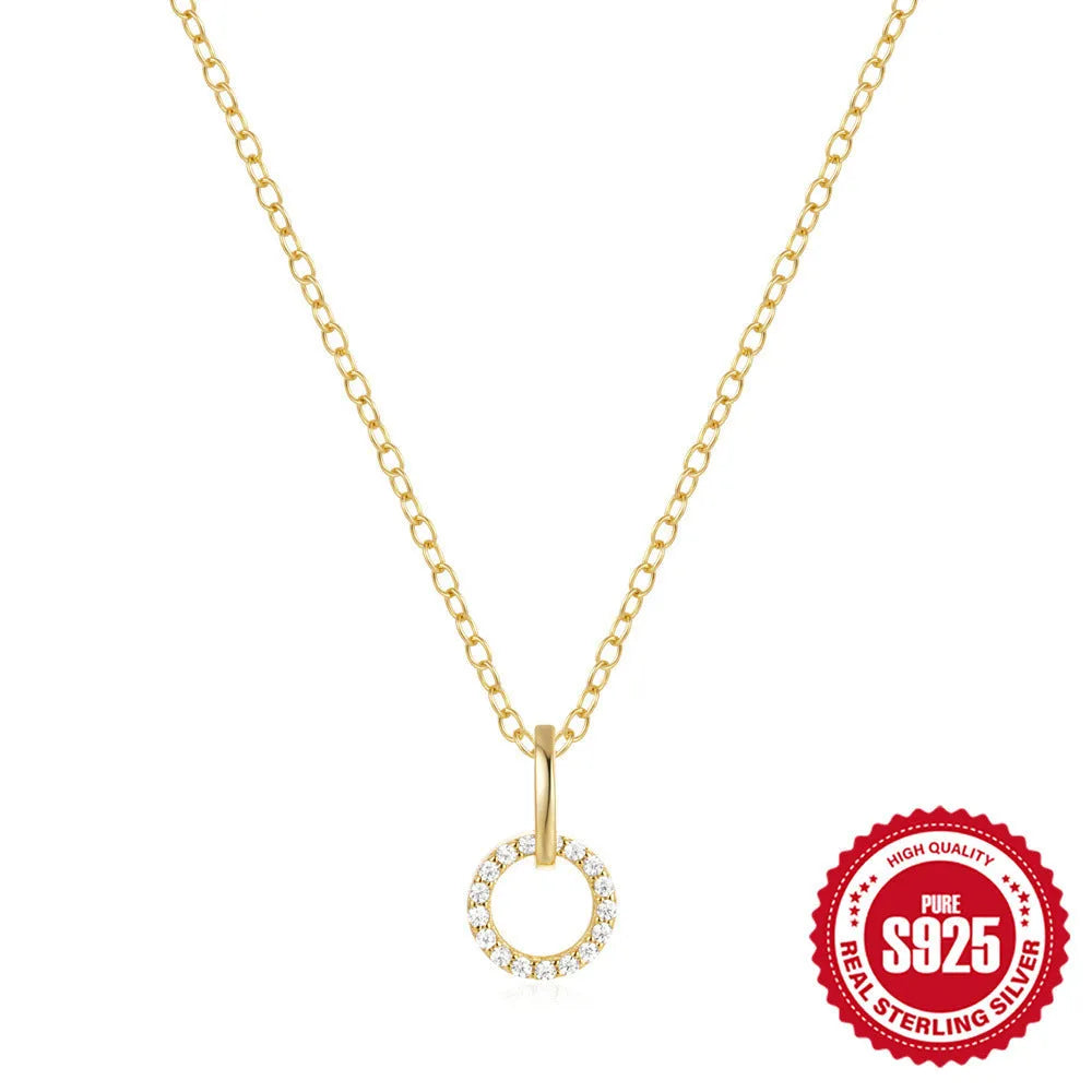 Gold-coloured sterling silver adjustable clavicle chain with interlocking geometric zircon pendant.