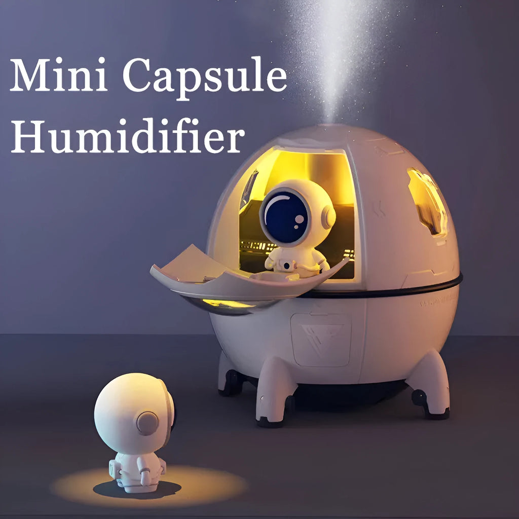 Purple astronaut-shaped USB desktop humidifier with colourful LED light on wooden desk