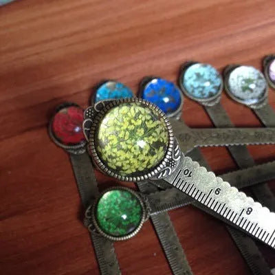 Handmade dried gypsophila flower bookmark ruler showing lace flowers, daffodils, and clovers on 12cm length