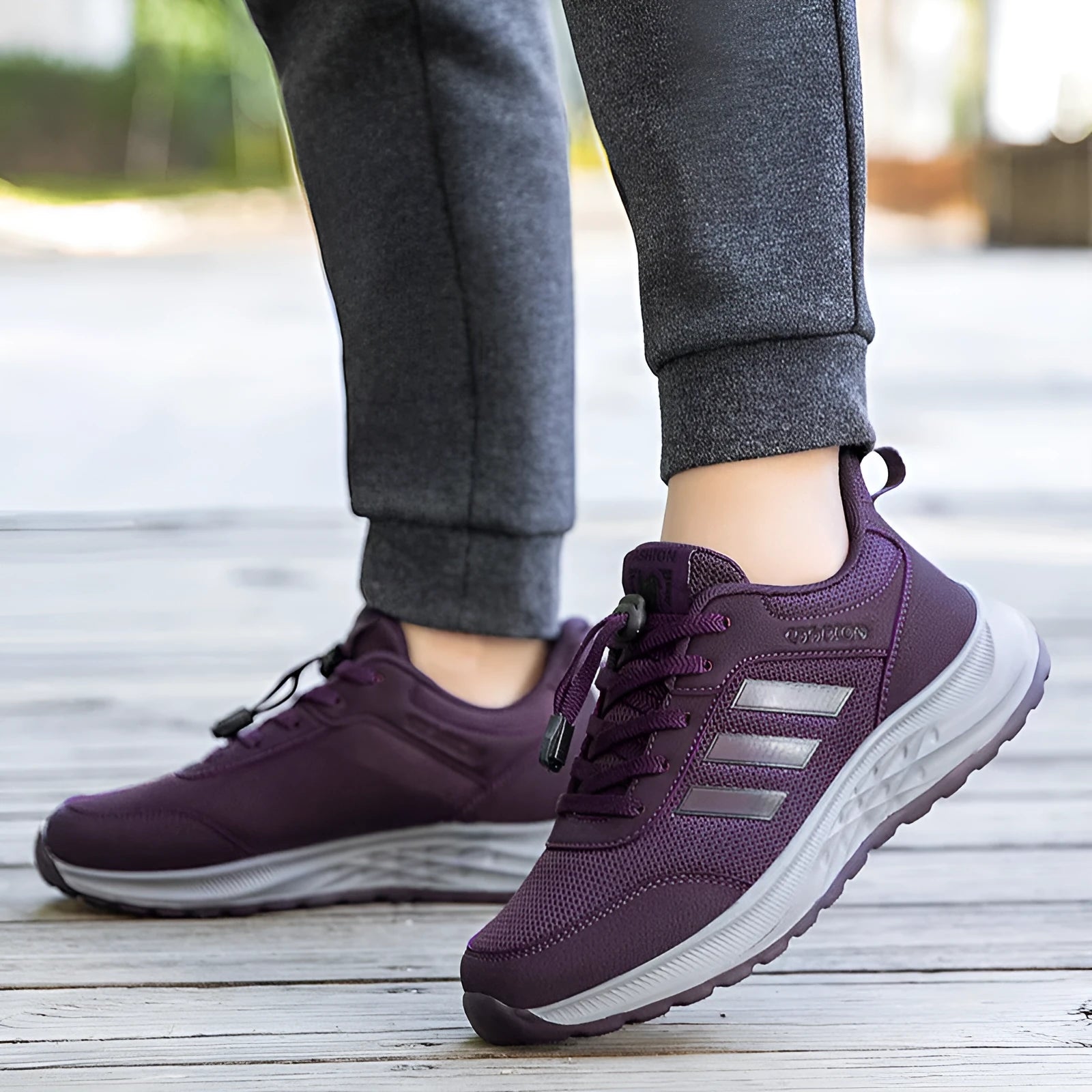 Men's and women's casual slip-on sneakers with mesh upper and elastic band in black, dark grey, purple, and purplish red.