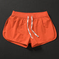 Men's loose beach shorts in orange red, fluorescent green and black colours with micro elasticity fabric