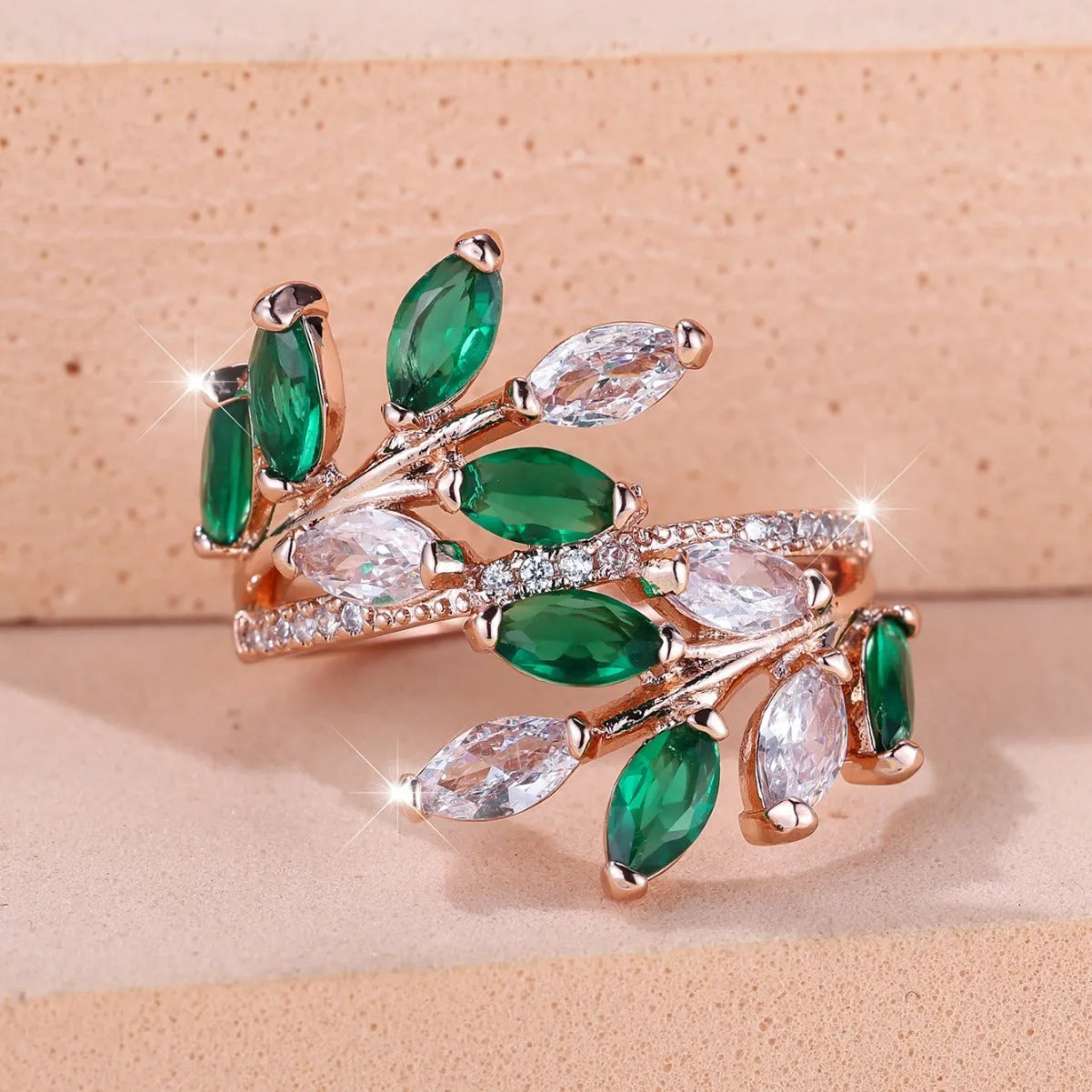 Adjustable copper leaf ring in platinum or rose gold finish on a white background