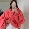 Watermelon red mulberry silk sleeveless hooded sweater on hanger showing loose fit and hood detail