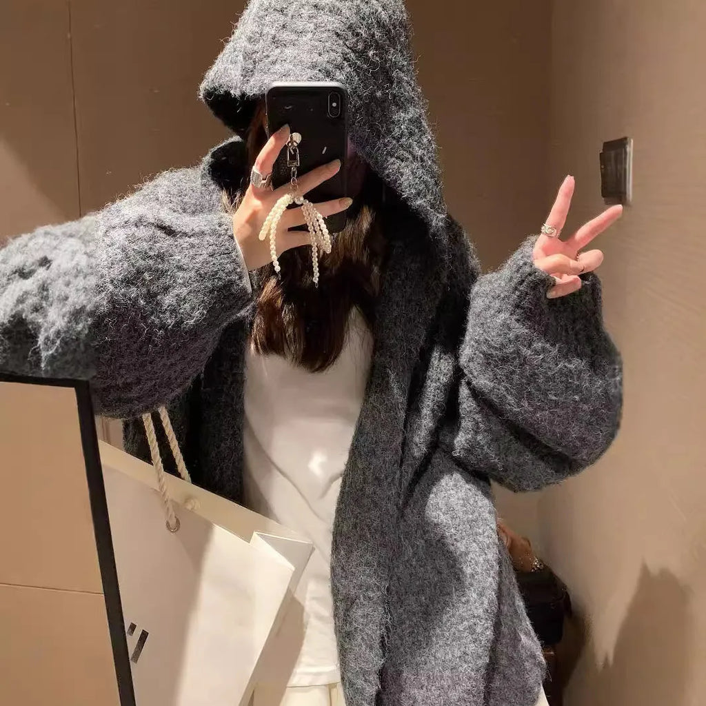Brown loose-fit hooded cardigan sweater for women on a hanger