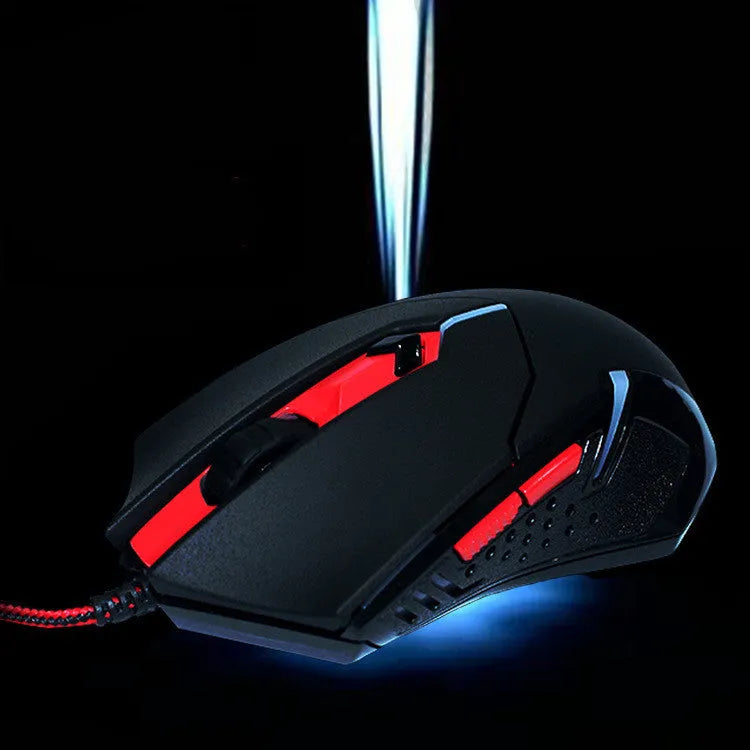 Black and red USB wired optical gaming mouse on a desk surface.