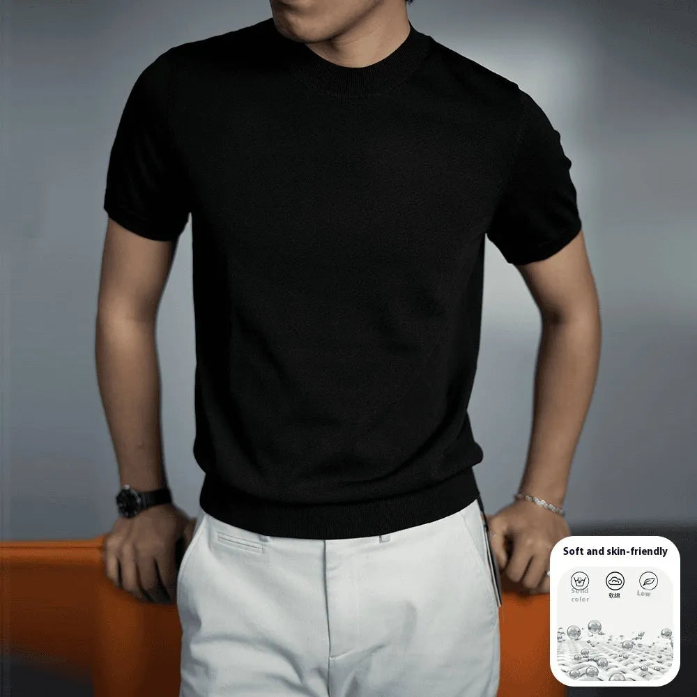 Man wearing a solid colour knitted t-shirt with round neck and short sleeves, showcasing business casual style.