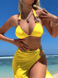 Rose red three-piece swimsuit with bikini top, briefs, and a light diamond mesh cover-up skirt laid flat.