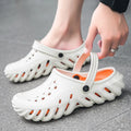 Men's beige hollow out EVA sandals with non-slip sole on a grey background.