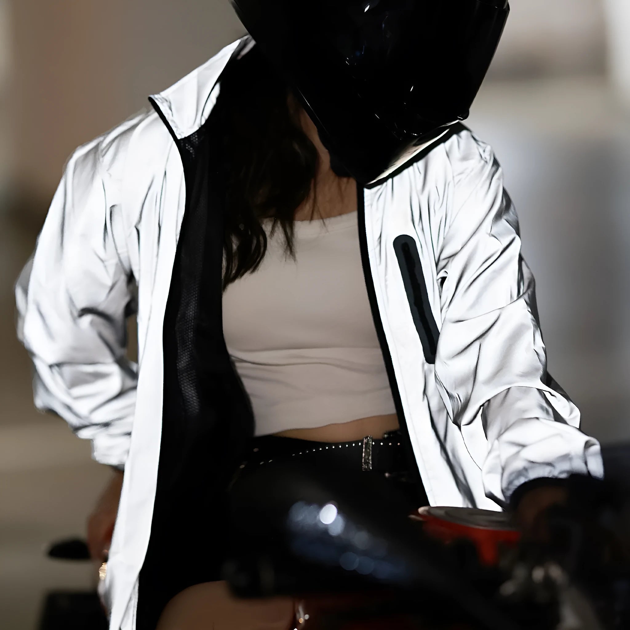 Silver waterproof polyester long sleeve top shown on a hanger.