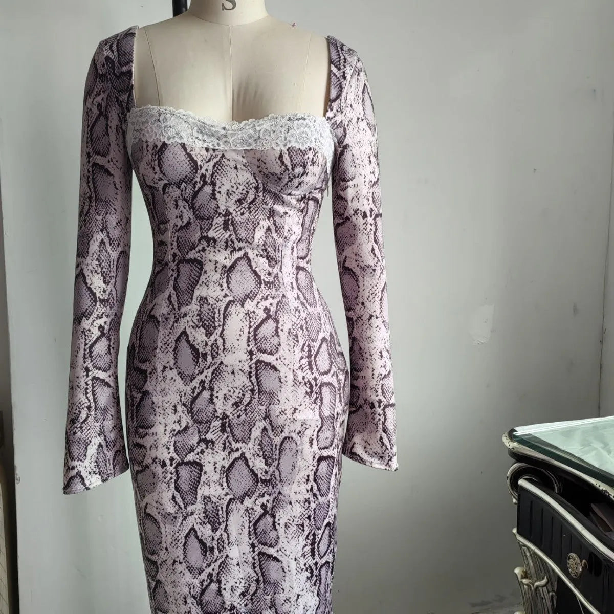 Grey women's slim fit lace dress with long sleeves and A-line skirt showing digital 3D printed pattern.
