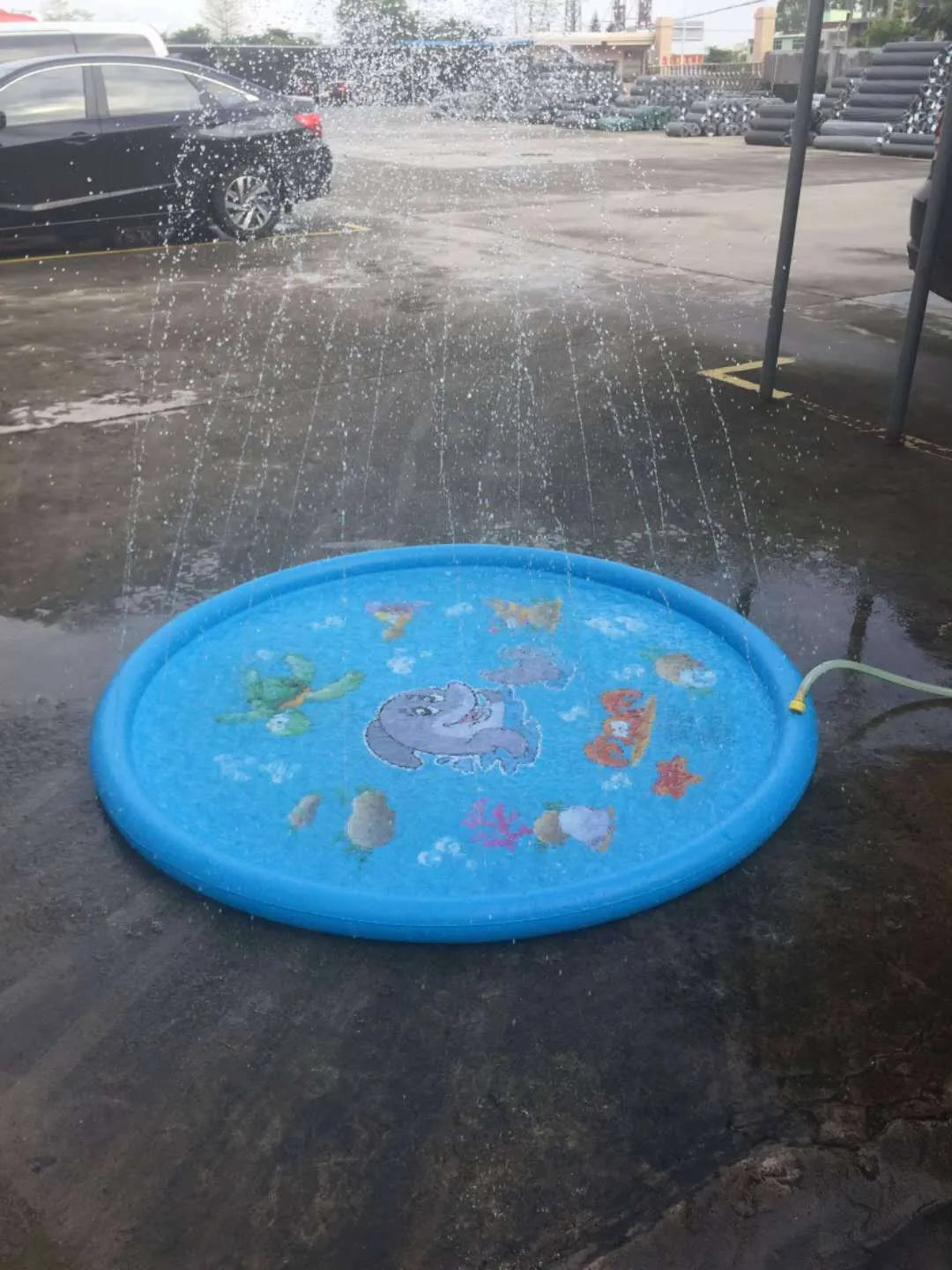 Blue PVC water spray play mat with marine animal graphics measuring 100cm by 170cm for children's outdoor water games