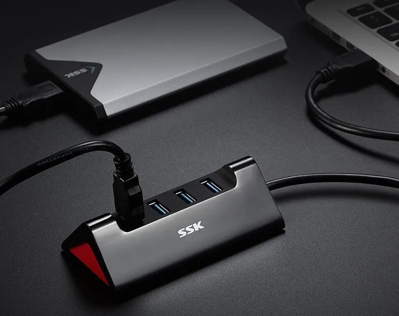 Black USB expansion dock with four USB ports and Micro USB power connection measuring 100mm x 50mm