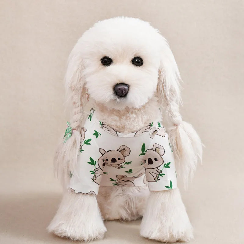 A small dog wearing a casual, printed polyester T-shirt, showing the full design and fit.