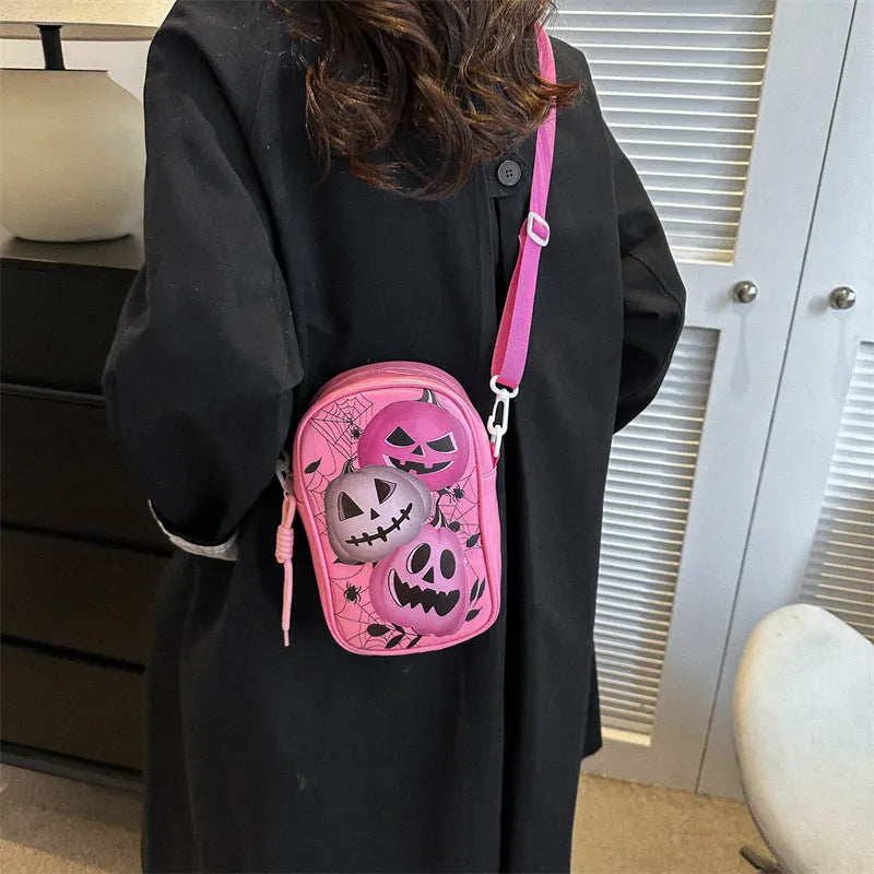 Halloween graffiti crossbody phone bag with cartoon pumpkin, ghost, and bat print in black.