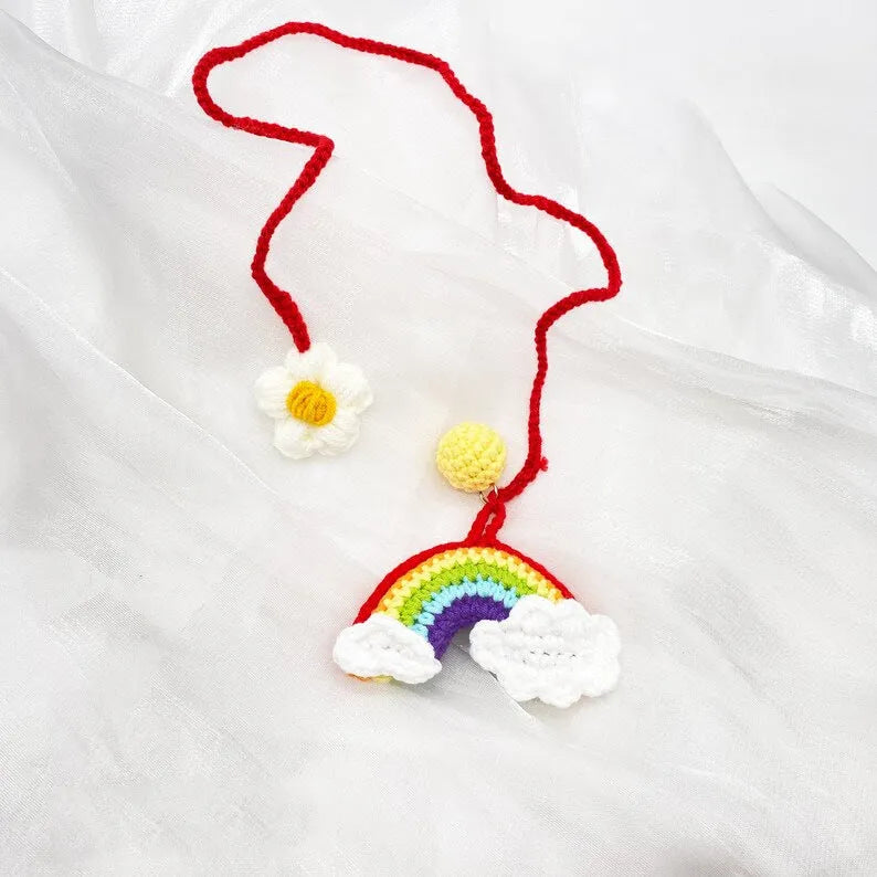 Handmade crocheted avocado-shaped and rainbow pattern car pendants made from wool yarn.