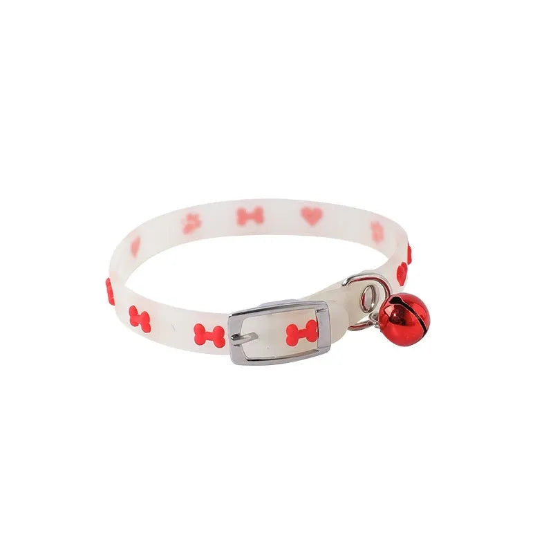 Luminous adjustable cat collar with a metal bell in a paw print pattern on a silicone rope.