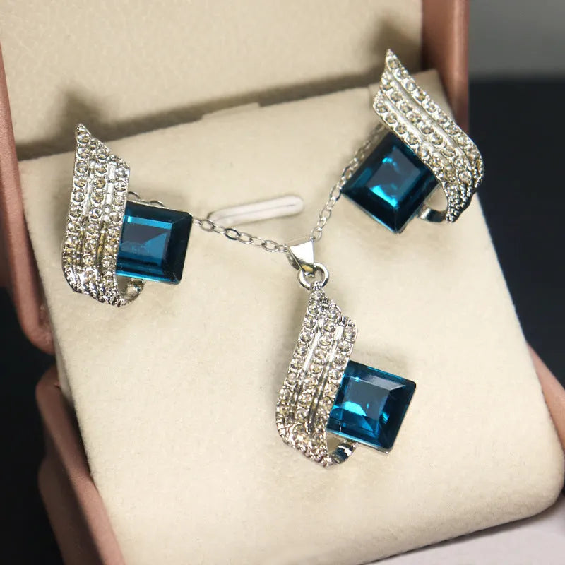 Women's necklace and earring set with a glass pendant on an electroplated alloy cross chain.