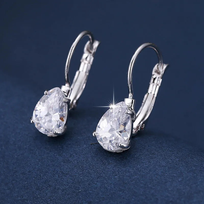Drop-shaped women's fashion earrings in gold or platinum finish with an inlaid gem