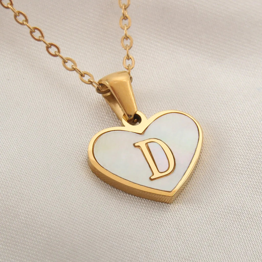Gold-plated heart necklace with white shell centre on an adjustable stainless steel chain.