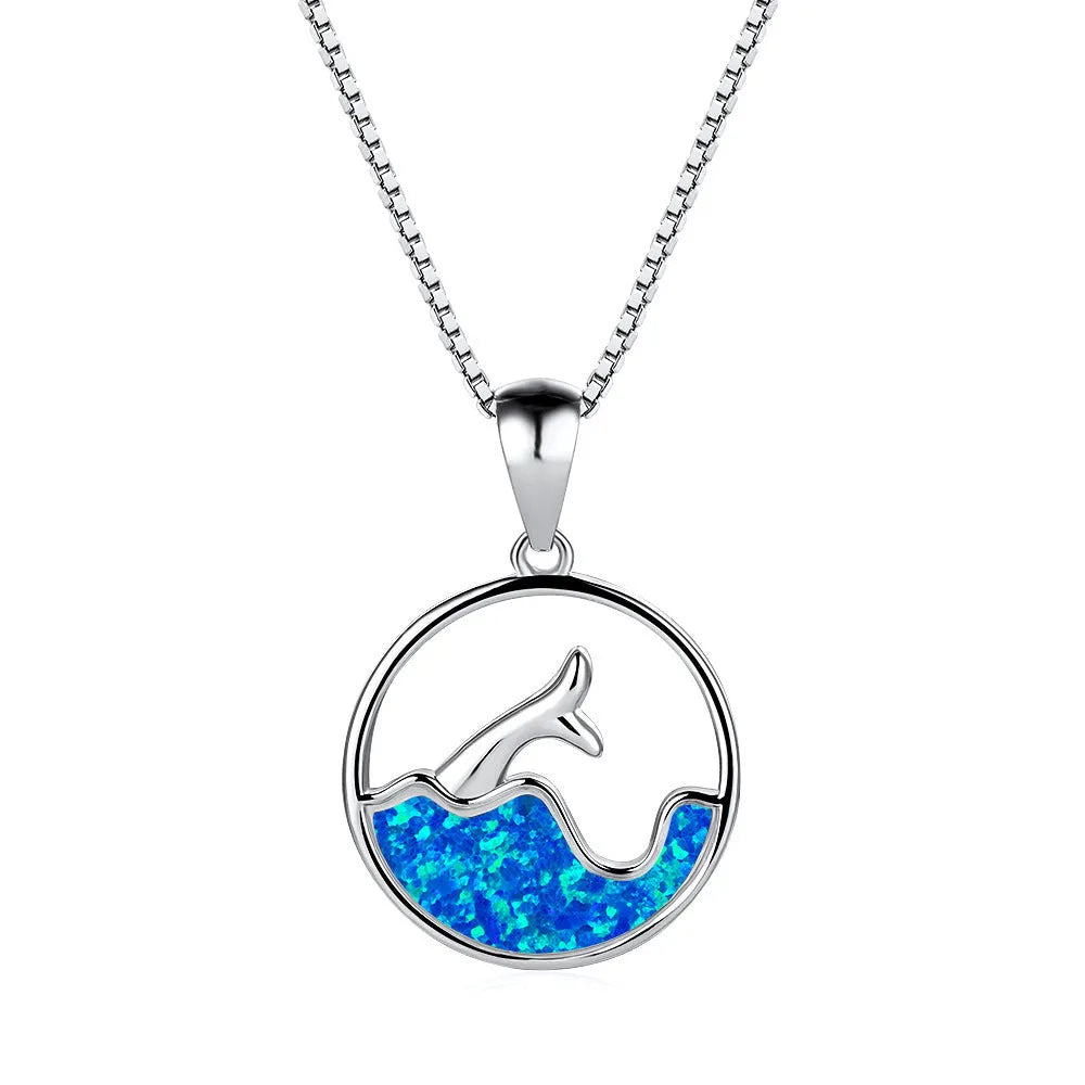 Gold tone geometric fishtail pendant necklace with a round blue opal centre on a chain.