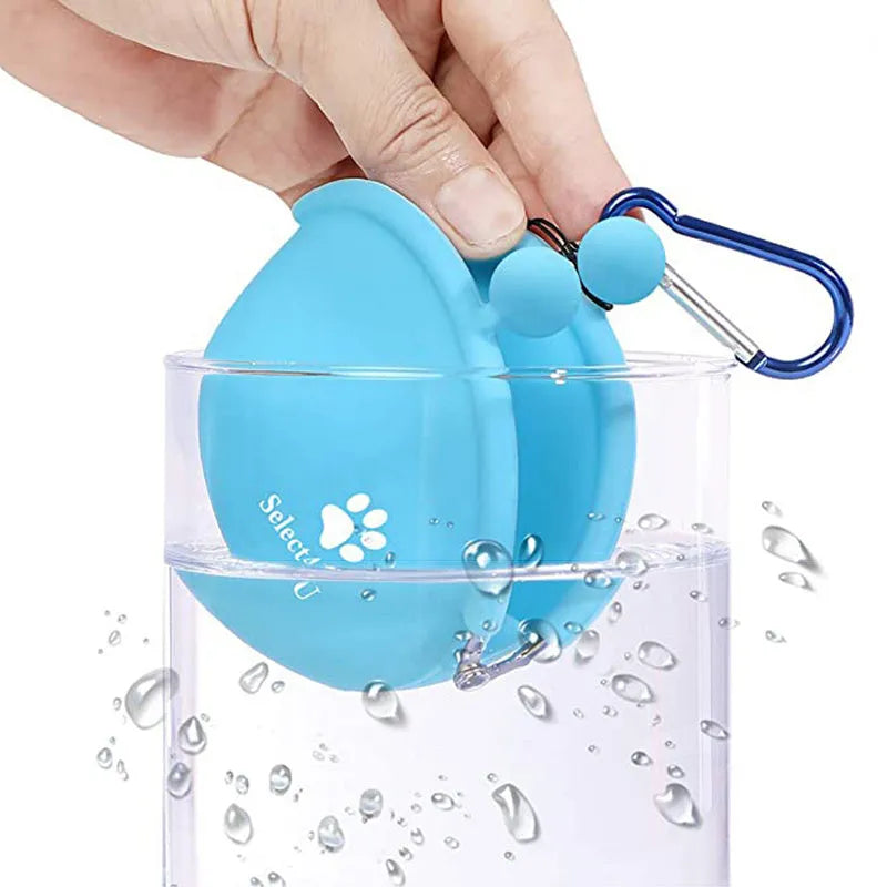 Yellow silicone dog training treat pouch with hook-and-loop strap, shown attached to a waistband.