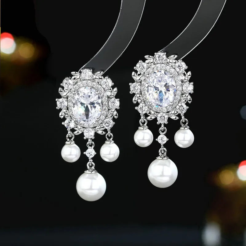Oval zircon inlaid pearl tassel earrings with geometric design and decorative hanging elements