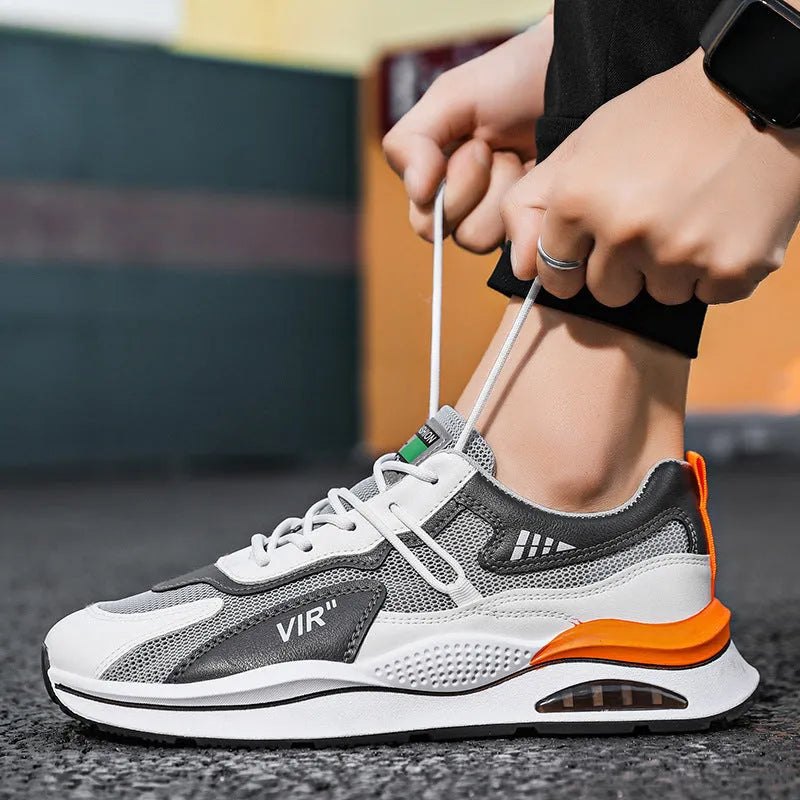 Men's gray mesh running shoes with round toe and visible stitching, shown from side view