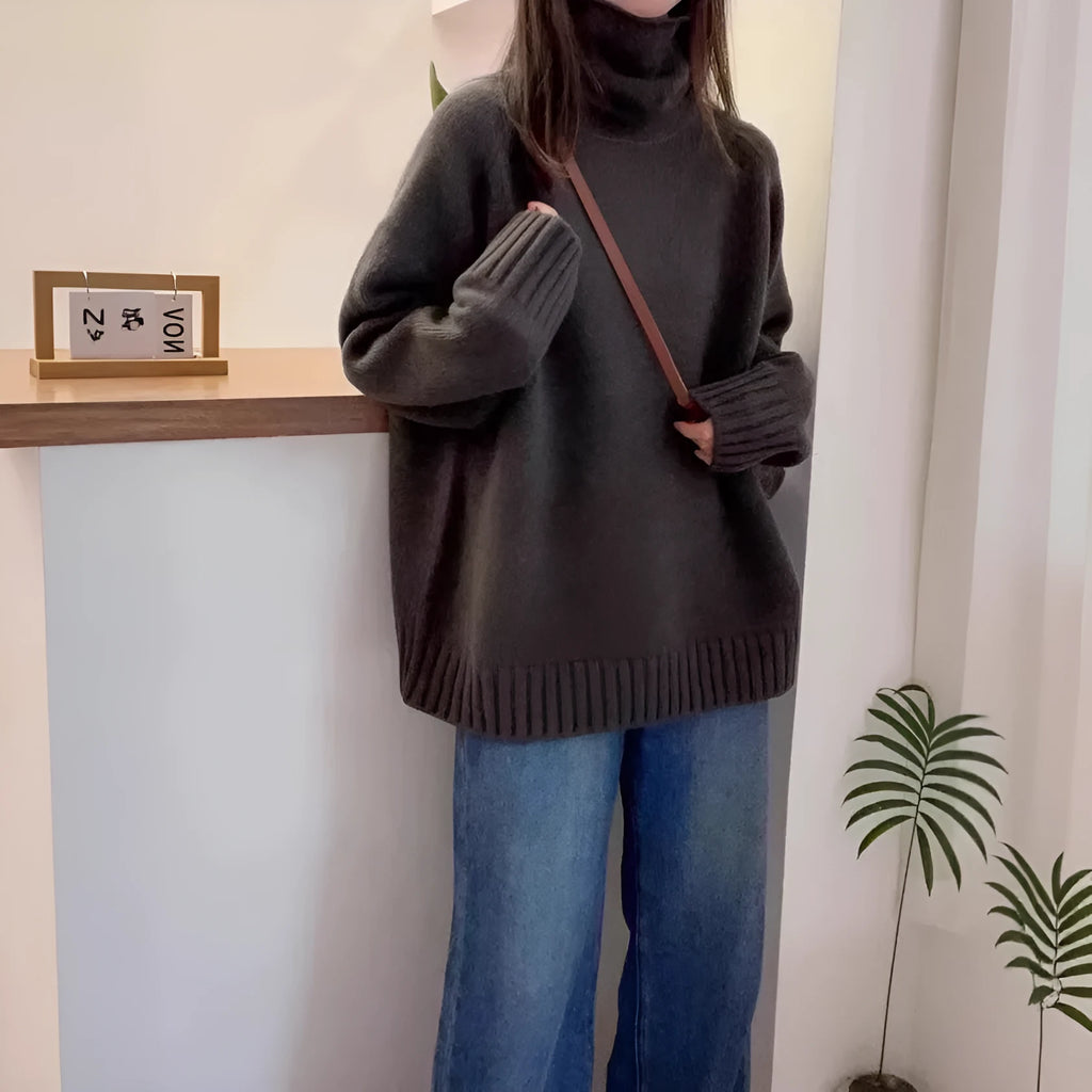 Women's loose black turtleneck sweater with a thick curling pile collar, casual style.
