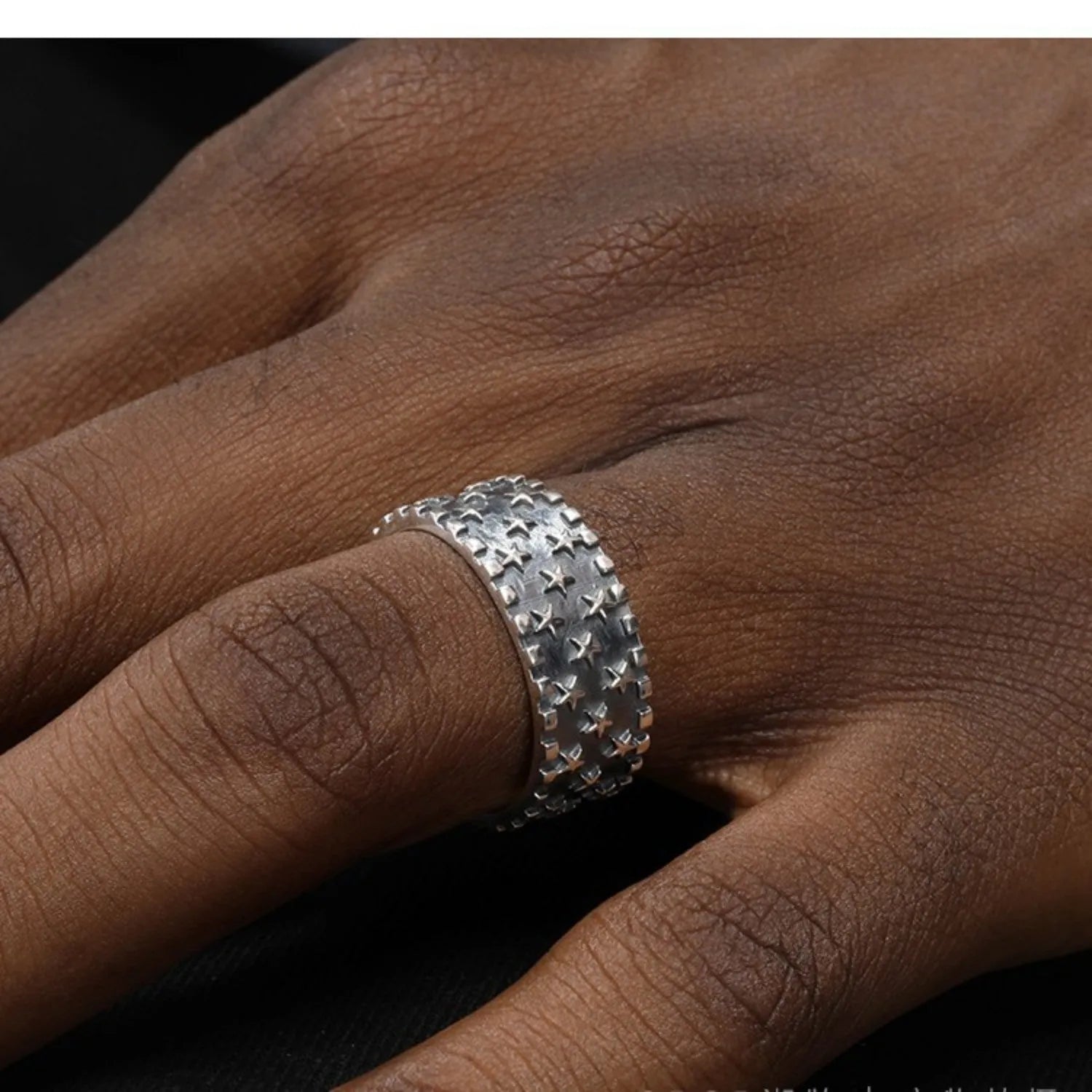 Silver adjustable ring with geometric five pointed star pattern on finger