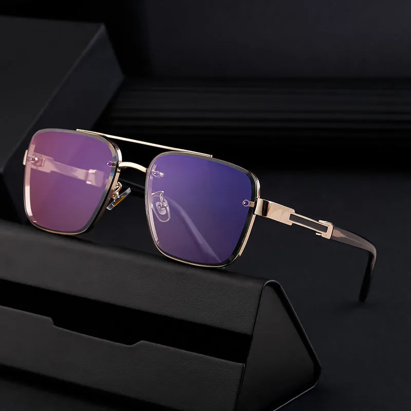 Men's vintage sunglasses with gold frame and grey lenses on a plain background.