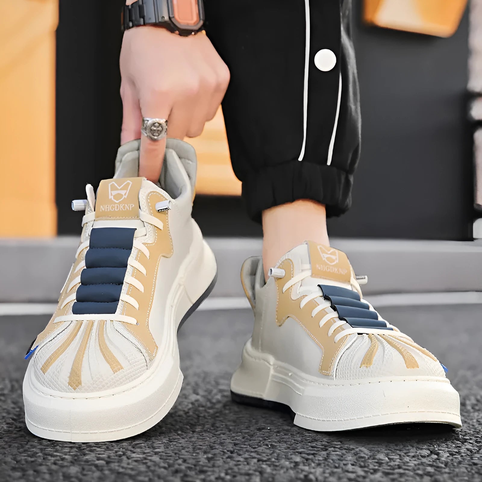 Men's beige low-top casual sneakers with an elastic band and leather stitching detail.