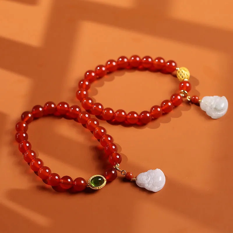 Handcrafted women's bracelet with red agate stone, amber beads, jade and Buddha pendants.