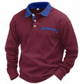 Man wearing a long-sleeved waffle-textured polo shirt in a dark colour with an asymmetric design detail.