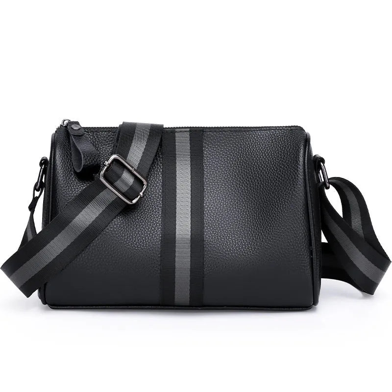 Black genuine leather one-shoulder crossbody bag showing its large size and crossbody strap.