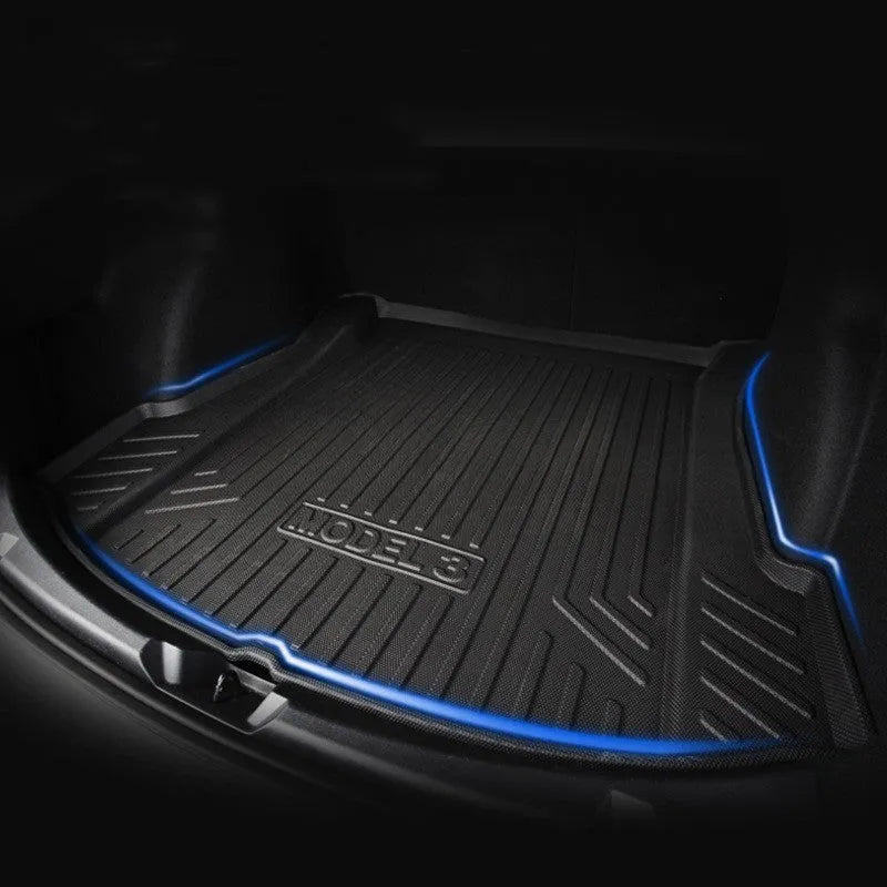 Black rubber floor mat for Tesla car interior with textured TPE footrest section.