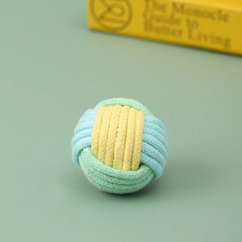 Small handmade cotton plush ball cat toy in blue powder, green blue, or pink green colours, 5cm diameter.