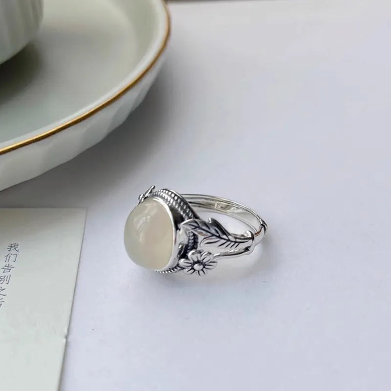Adjustable open-mouth vintage ring in antiqued copper with a white chalcedony-style colour.