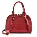 Large shiny black PU leather crossbody bag with shell shape, showing interior polyester lining and shoulder strap