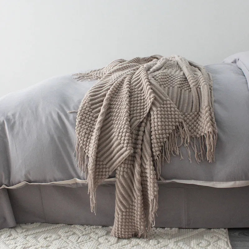 Small grey polyester fibre blanket folded to show its texture and colour.