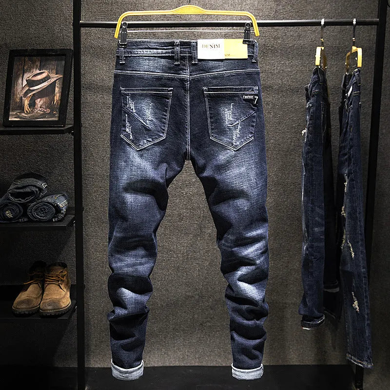 Men's slim-fit skinny jeans in dark blue denim fabric with a mid-rise waist