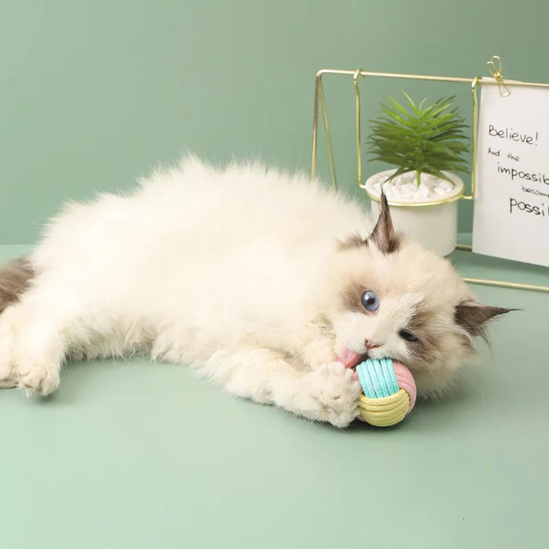 Small handmade cotton plush ball cat toy in blue powder, green blue, or pink green colours, 5cm diameter.