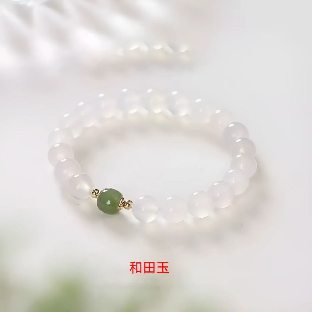 A handmade white agate style crystal bracelet with cinnabar inlay, shown in 6mm and 8mm bead sizes.
