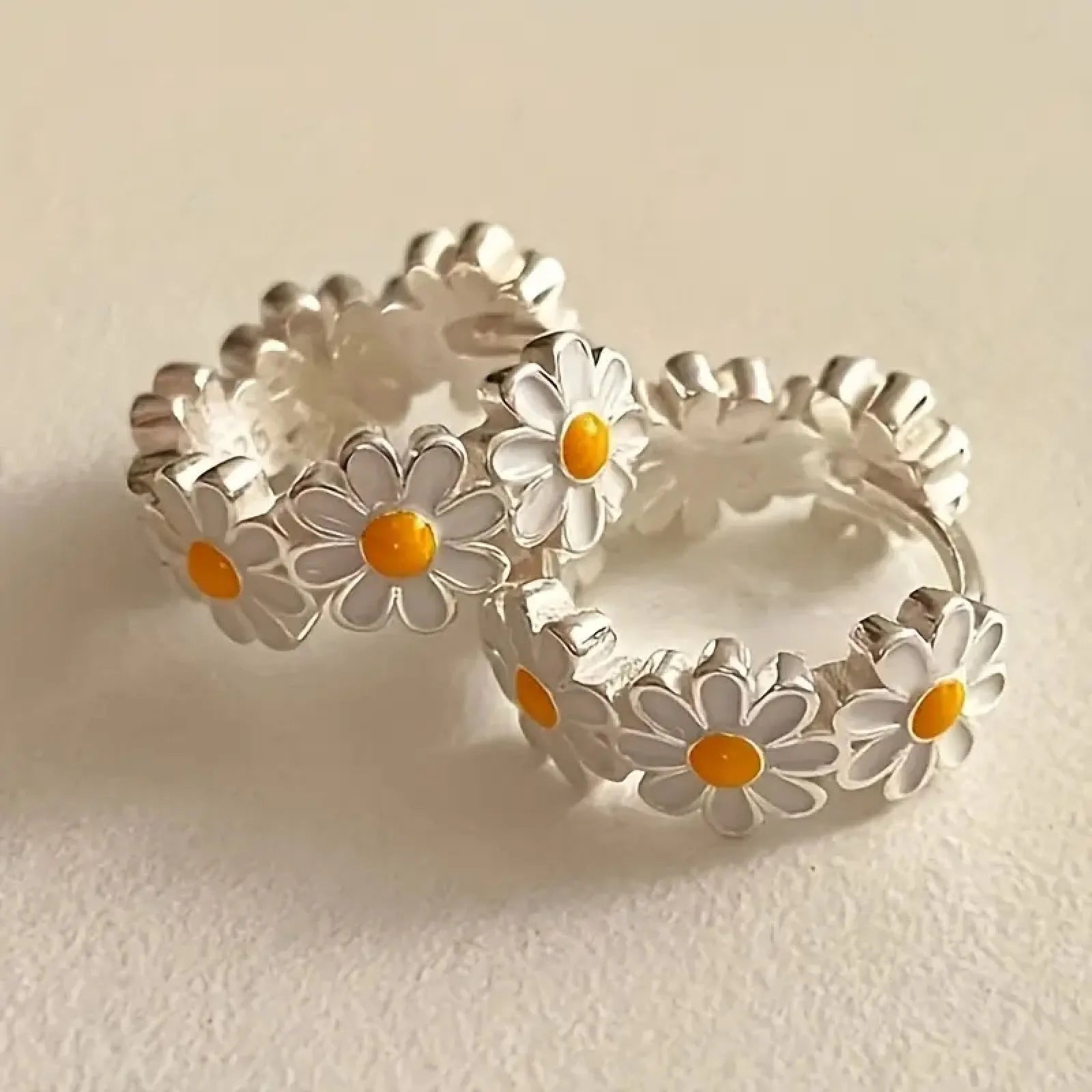 White daisy flower ring earrings with a platinum-colour gem setting.