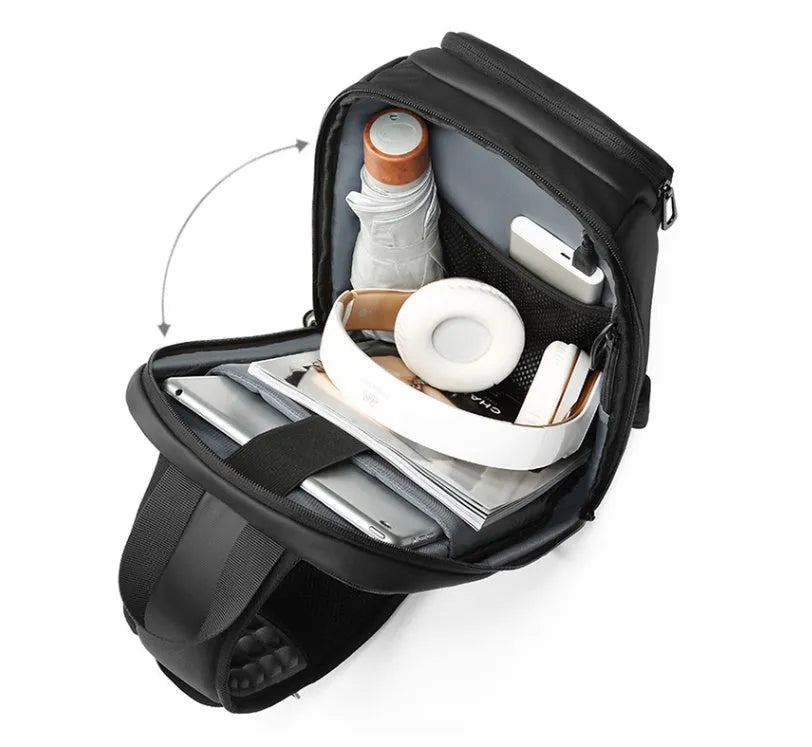 Black medium outdoor shoulder bag showing computer pocket, soft handle, and single air cushion strap.