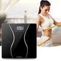 Black electronic bathroom scale with digital display on tempered glass platform